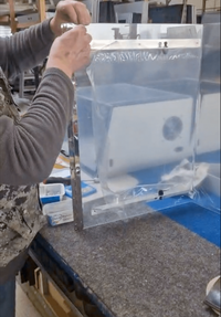 Soundproof printer housing made of wood, acoustic foams, and a glass door – in‑house production by Lehmann IT.